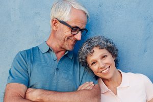 A mature couple smiling in a portrait with the benefit of restorative dentistry in Goshen.